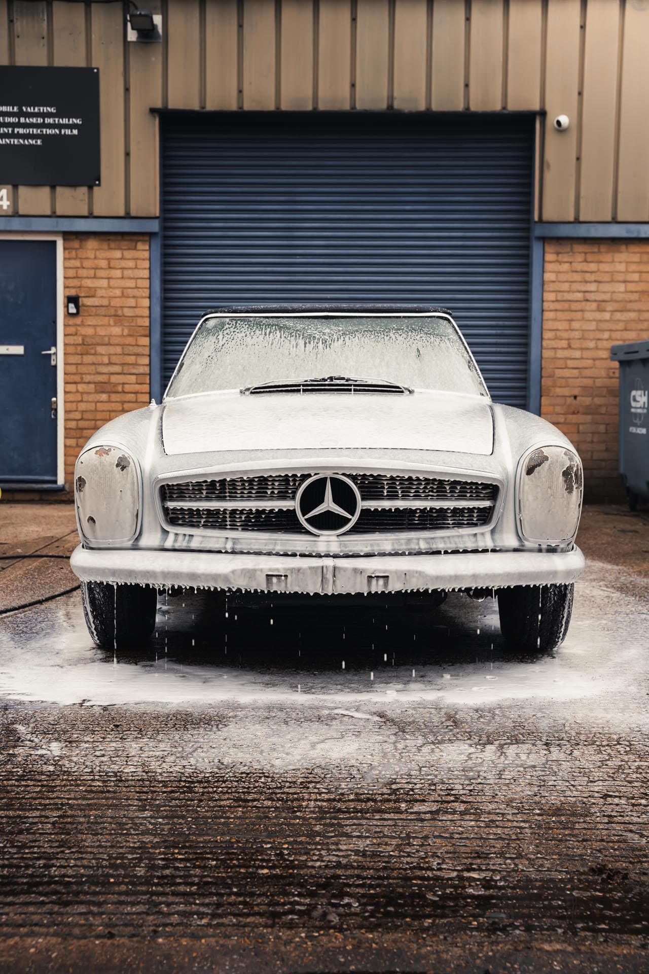 Vehicle being washed during a maintenance valet